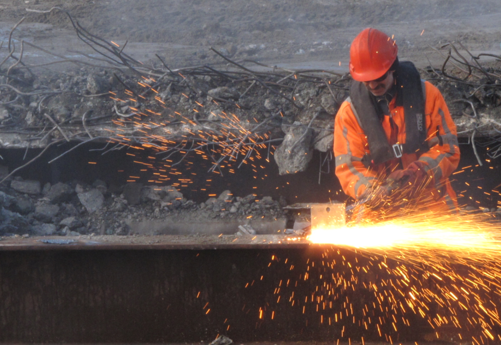 AI edge computing system monitoring construction site safety with video analytics detecting PPE compliance and restricted area access